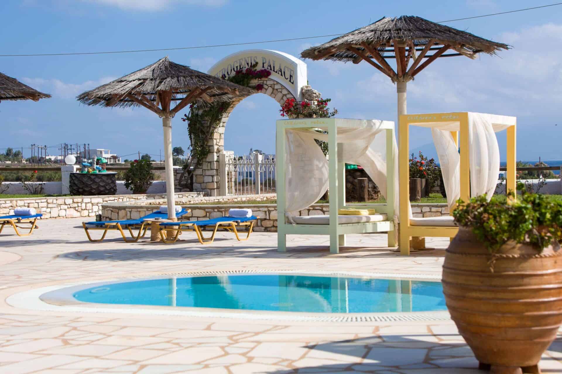 Pool terrace with sunbeds at Fyrogenis Palace in Ambelas, Paros
