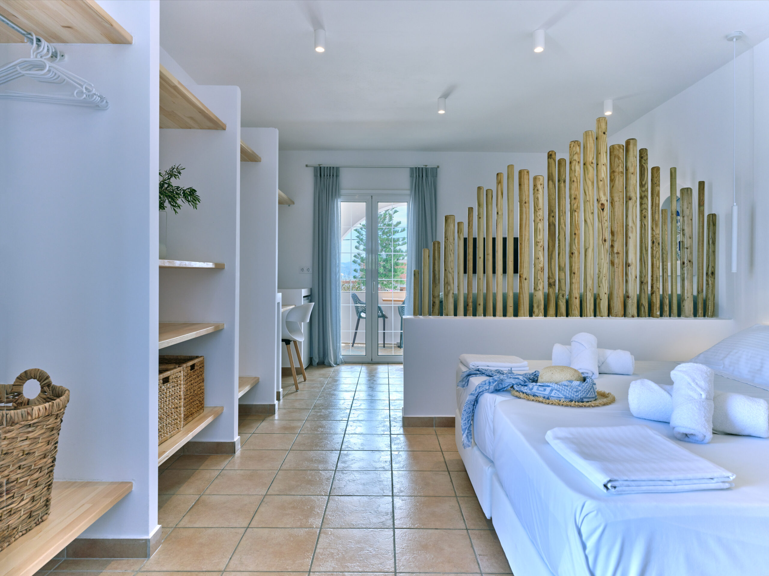White & Blue room long view showing bedroom and kitchen corner in Paros