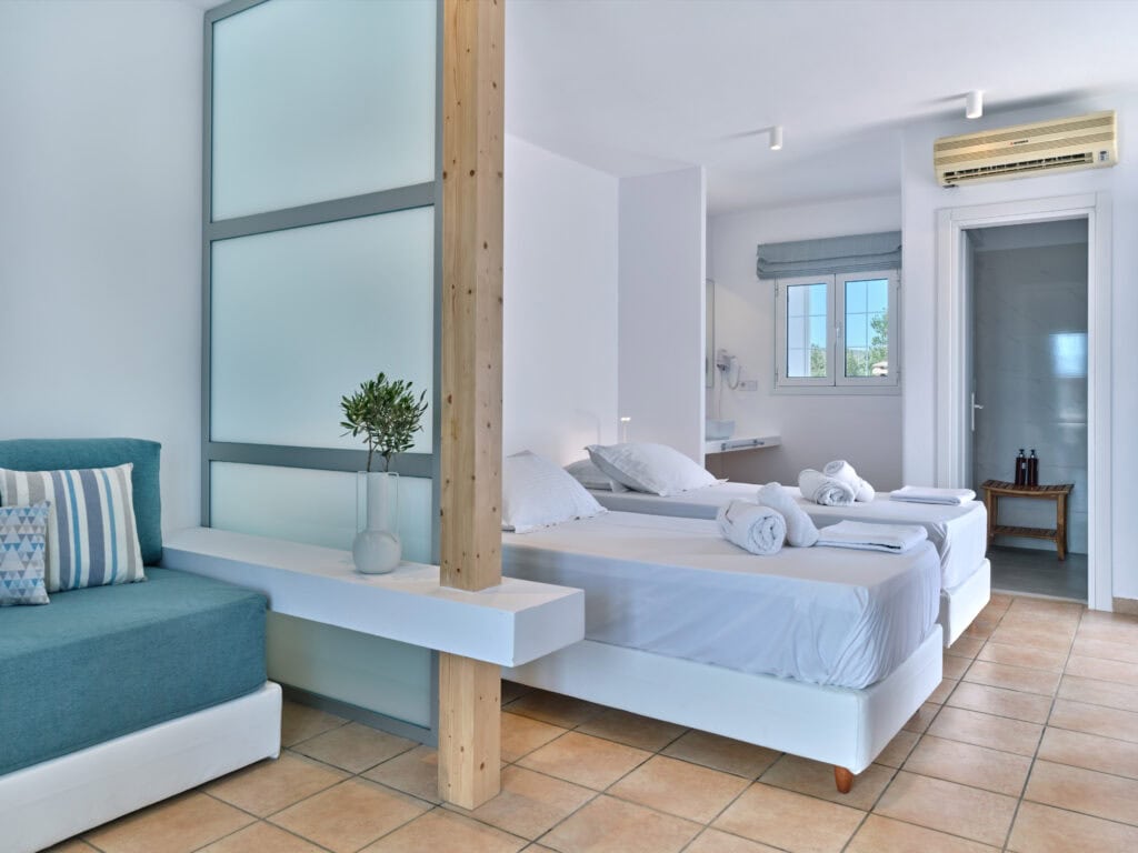 White & Blue room spacious bed and wooden feature wall in Paros island