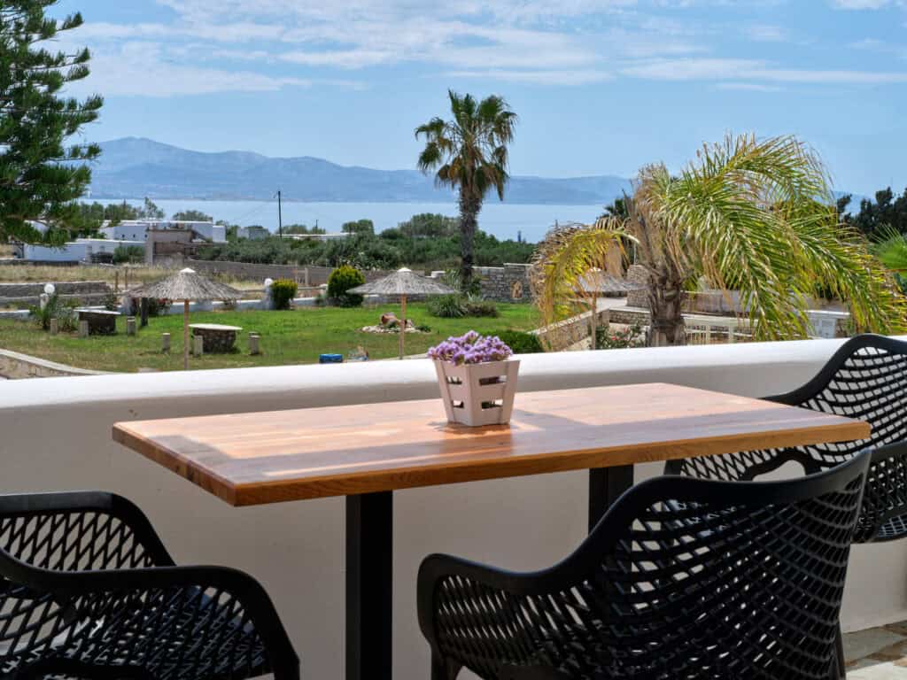 White & Blue room balcony outdoor table with sea and garden view in Ambelas