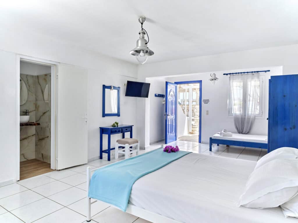 White & Blue Room spacious interior with double bed and living area - Ambelas Paros accommodatio