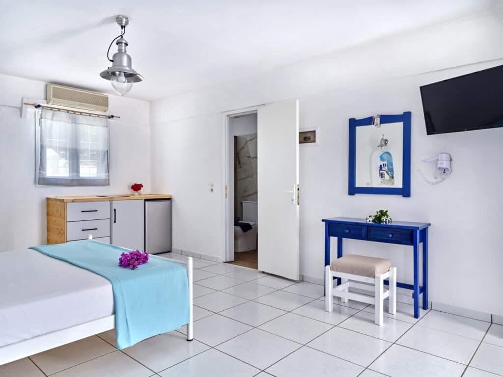 White & Blue Room interior with blue décor and kitchenette - Ambelas Paros hotel room