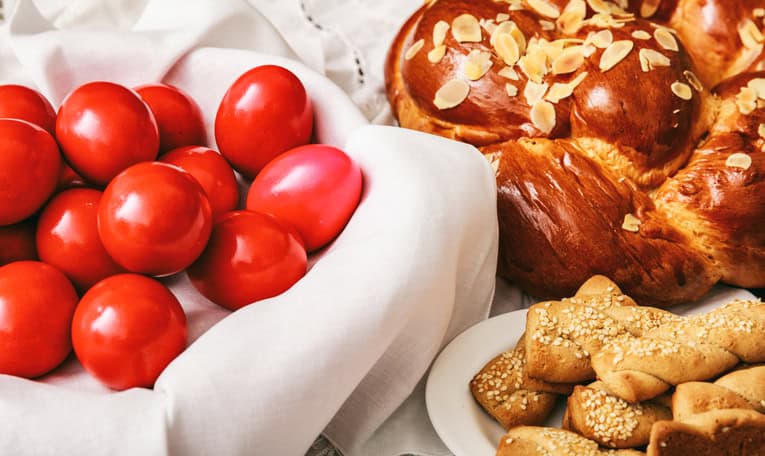 Traditional Greek Easter food with red eggs and tsoureki in Paros