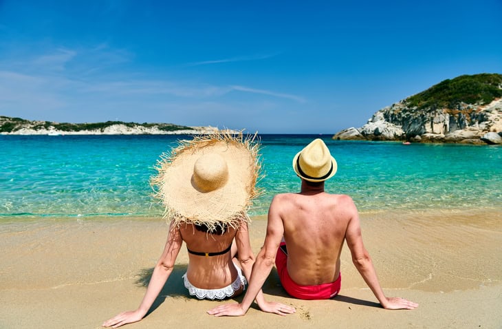 Couple relaxing on a quiet beach in Paros