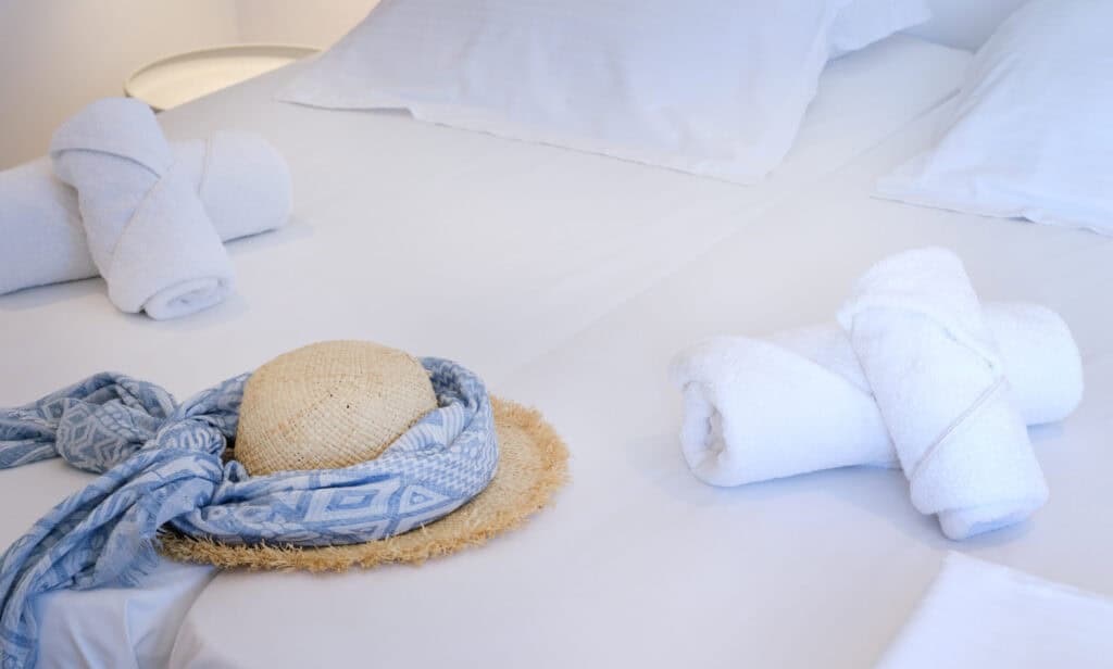 Bright and comfortable room interior with air conditioning, kitchenette and sea view at Fyrogenis Palace in Ambelas, Paros