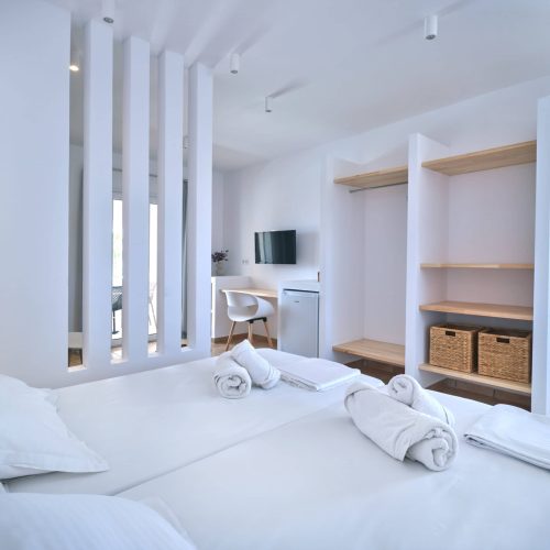 White & Blue room spacious interior with double bed in Paros island