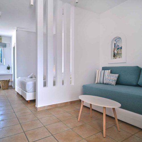 White & Blue room bedroom view with sofa and bed in Paros island