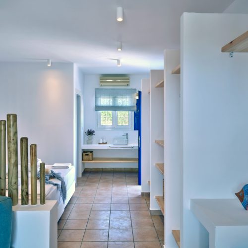 White & Blue room bedroom view through hallway in Paros island