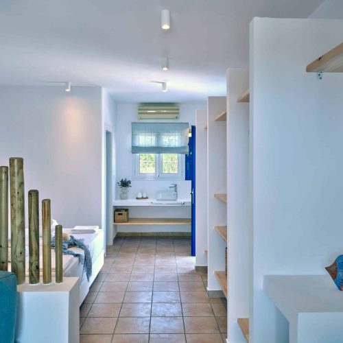 White & Blue room bedroom view through hallway in Paros island