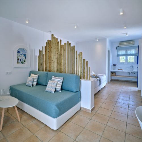 White & Blue room bright living space with decorative wood elements in Paros