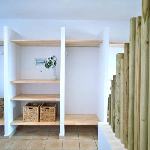 White & Blue room bed and wooden shelves interior in Ambelas, Paros