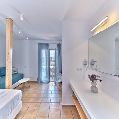 Bright bedroom area of the White & Blue room at Fyrogenis Palace Paros