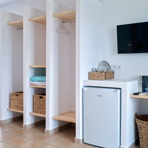 White & Blue room kitchenette and wardrobe area in Ambelas, Paros