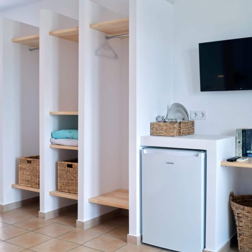 White & Blue room kitchenette and wardrobe area in Ambelas, Paros
