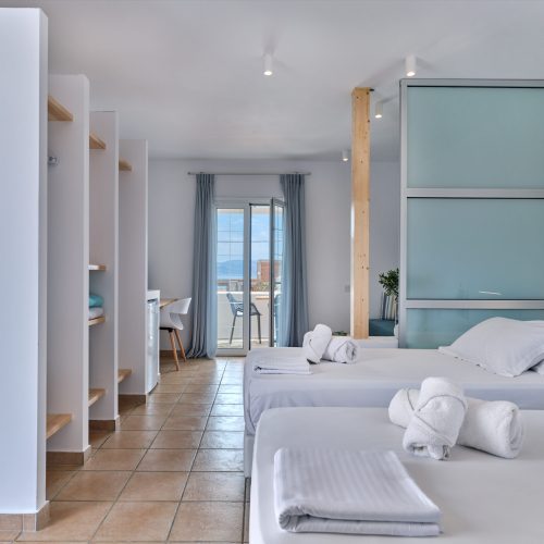 White & Blue room hallway with bright bedroom view in Paros island