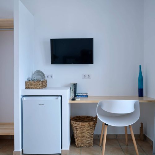 White & Blue room kitchenette area with fridge and shelves in Paros