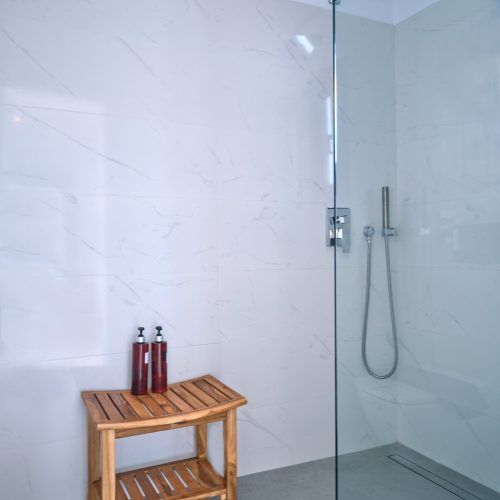 White & Blue room walk-in shower with modern fixtures in Ambelas, Paros