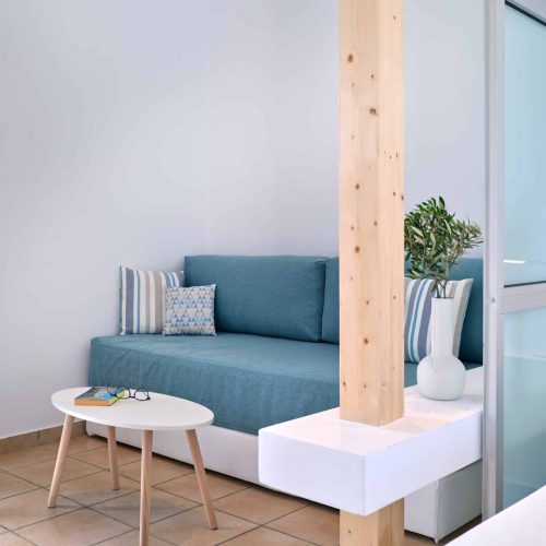 White & Blue room seating corner with wooden post design in Ambelas, Paros