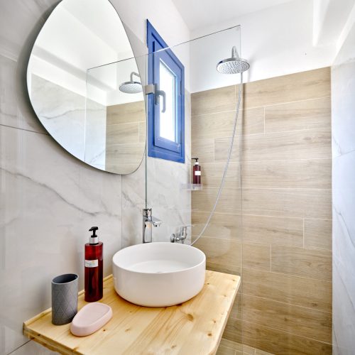 White & Blue Room bathroom with modern shower and natural wood sink -Ambelas Paros accommodation