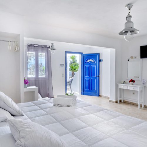 White & Blue Room bedroom with natural décor and soft lighting - Ambelas Paros hotel room