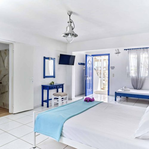 White & Blue Room spacious interior with double bed and living area - Ambelas Paros accommodatio