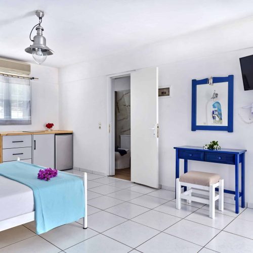 White & Blue Room interior with blue décor and kitchenette - Ambelas Paros hotel room
