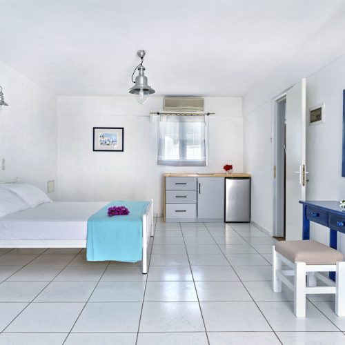 White & Blue Room dining and living area with natural light - Ambelas Paros sea-view rooms