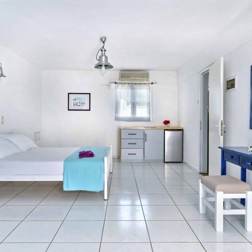 White & Blue Room dining and living area with natural light - Ambelas Paros sea-view rooms