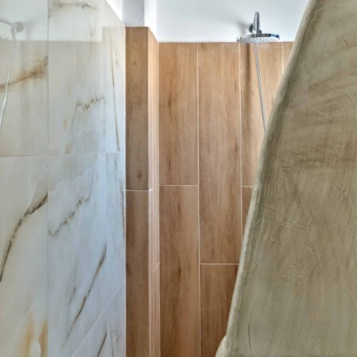 White & Blue Room modern walk-in shower with stone-style tiles - Ambelas Paros accommodation bathroom